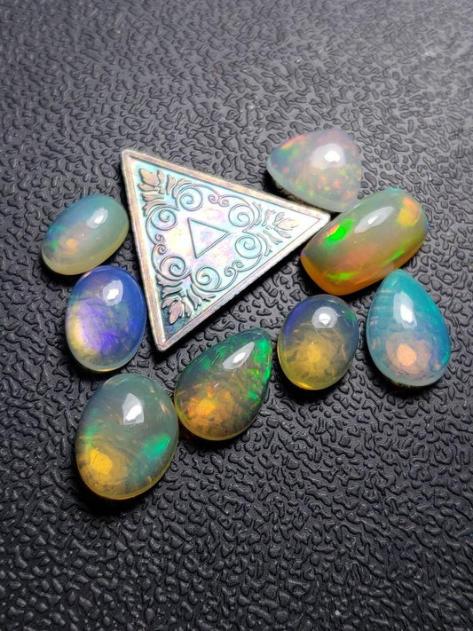 Lot of 8 small assorted Ethiopian Welo Opal Cabochons. Oval,tear drop,trillion. 8mm -11mm. 10 carats. Accents. Jewelry making supplies. (7)